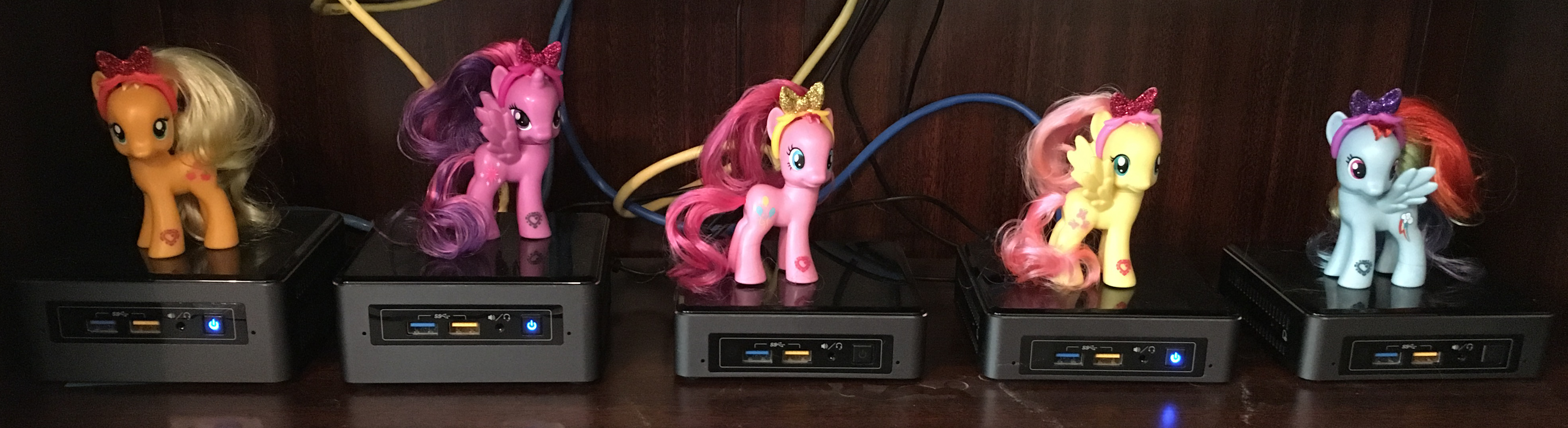 Five computers with My Little Ponies on top of them